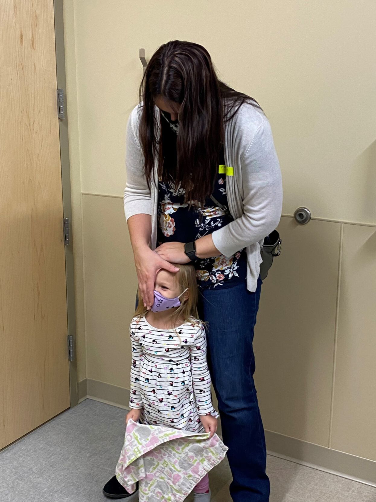 Dana helps Addison with eye exam
